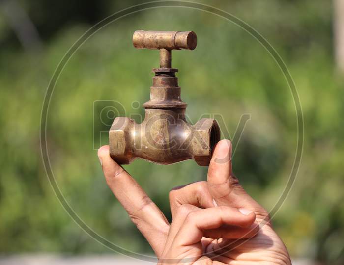Brass Water Tap Held In Hand