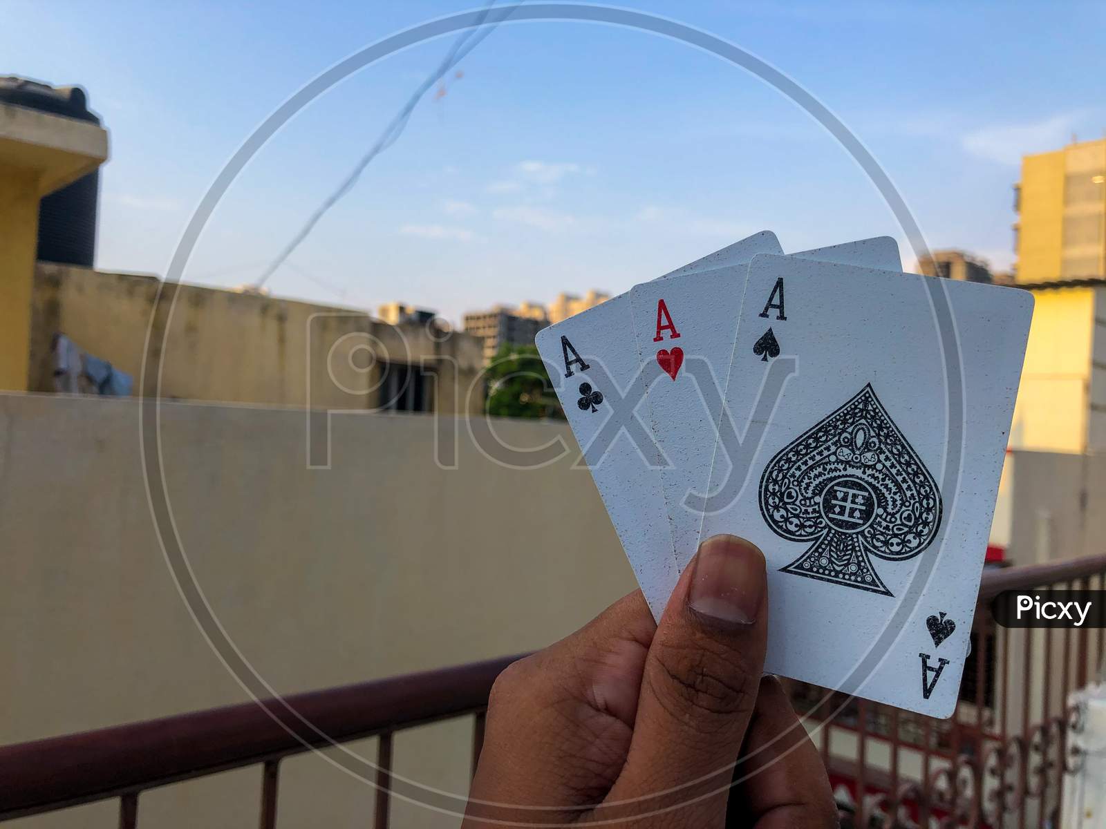 holding three cards in one hand with corporate background