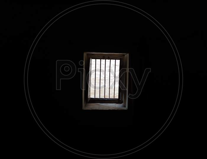 A WINDOW IS OPEN IN DARK ROOM AND LIGHT IS COMING FROM OUT SIDE