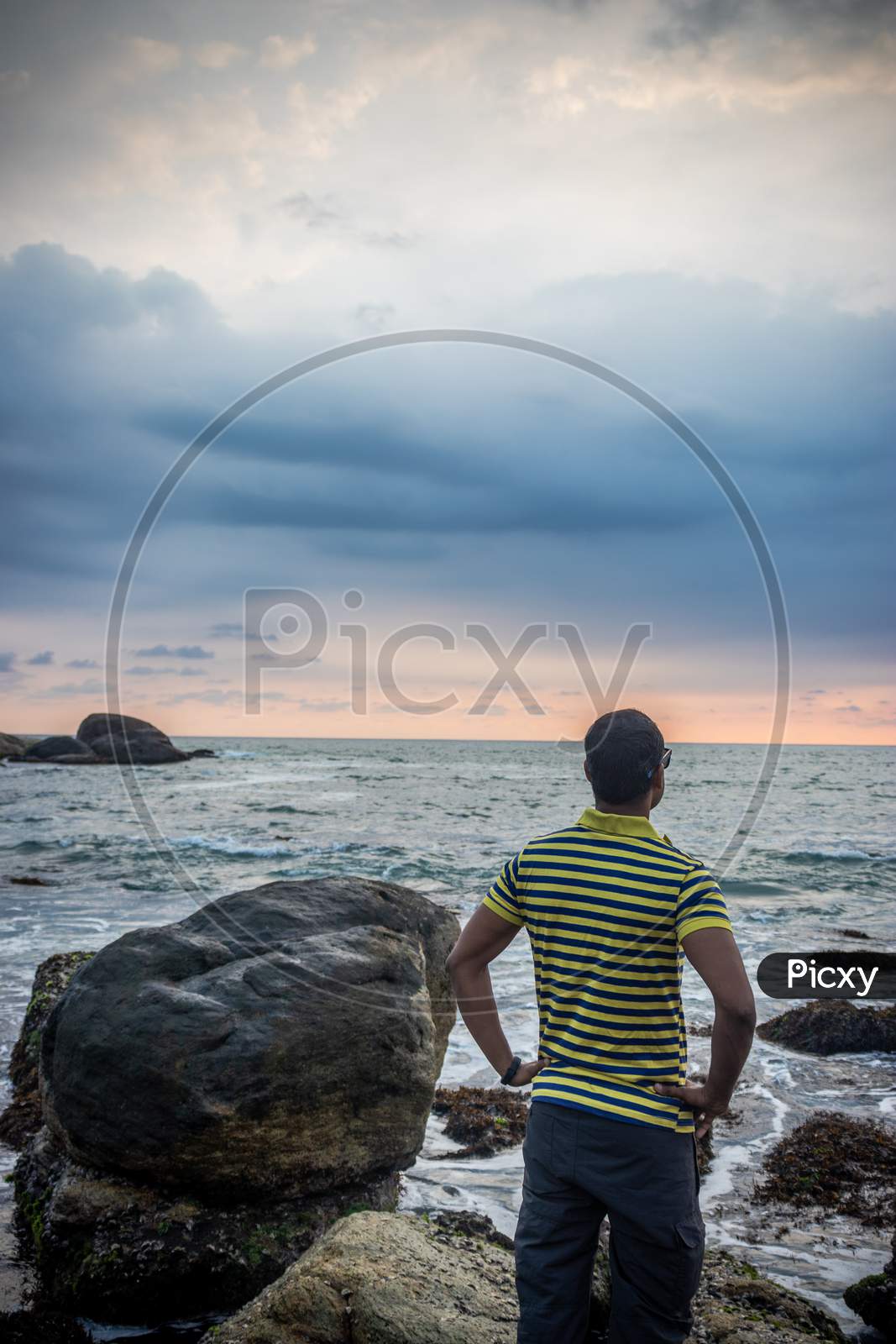 Man Isolated Watching The Sea Horizon With Dramatic Sky