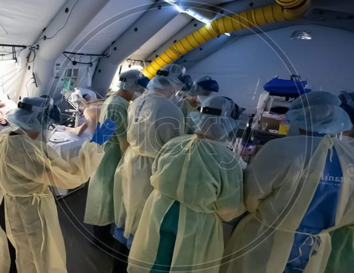 Photograph Of Doctors Team Standing In Covid 19 Hospital Have Shallow Depth Of Field Selective Focus Blur And Wonderland Background Wearing Mask Ppe Kit
