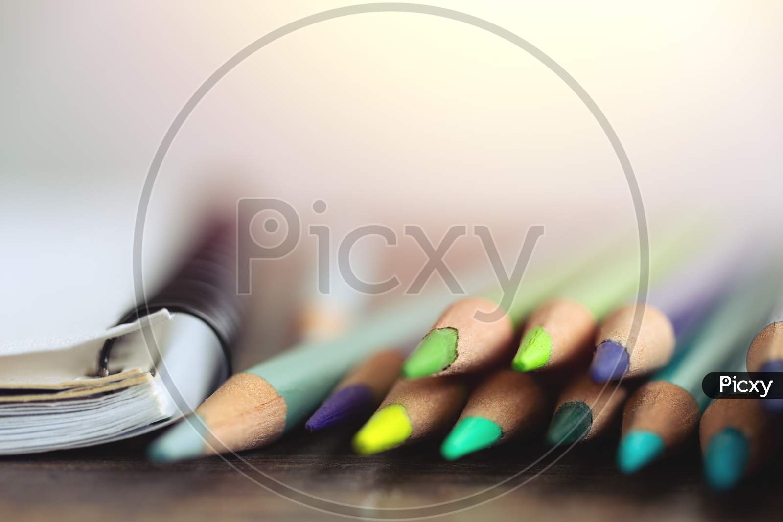 Close up of many colored pencils, macro. Art class student or workspace concept
