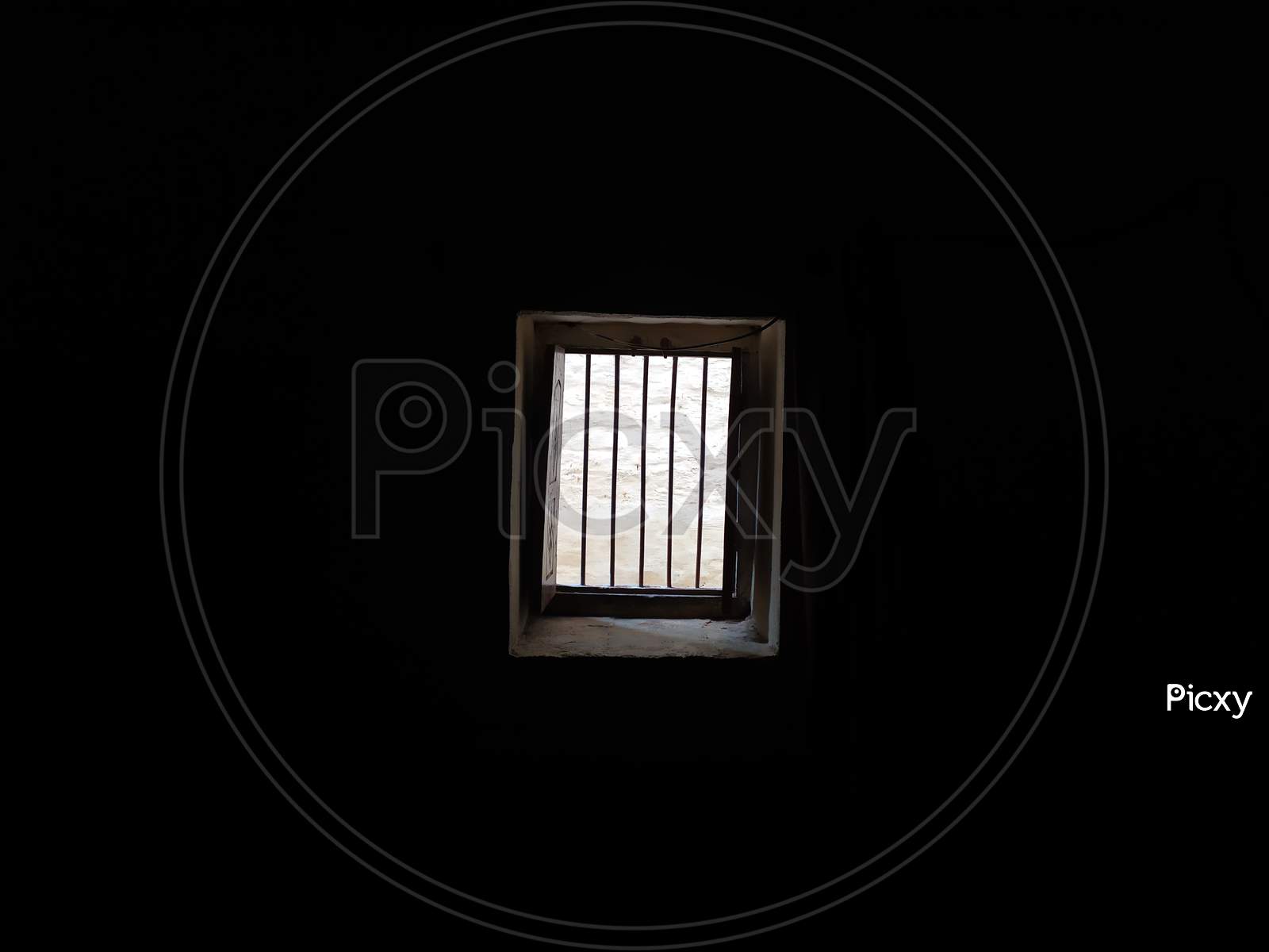 A WINDOW IS OPEN IN DARK ROOM AND LIGHT IS COMING FROM OUT SIDE