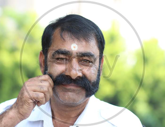 Indian man holding his mustache