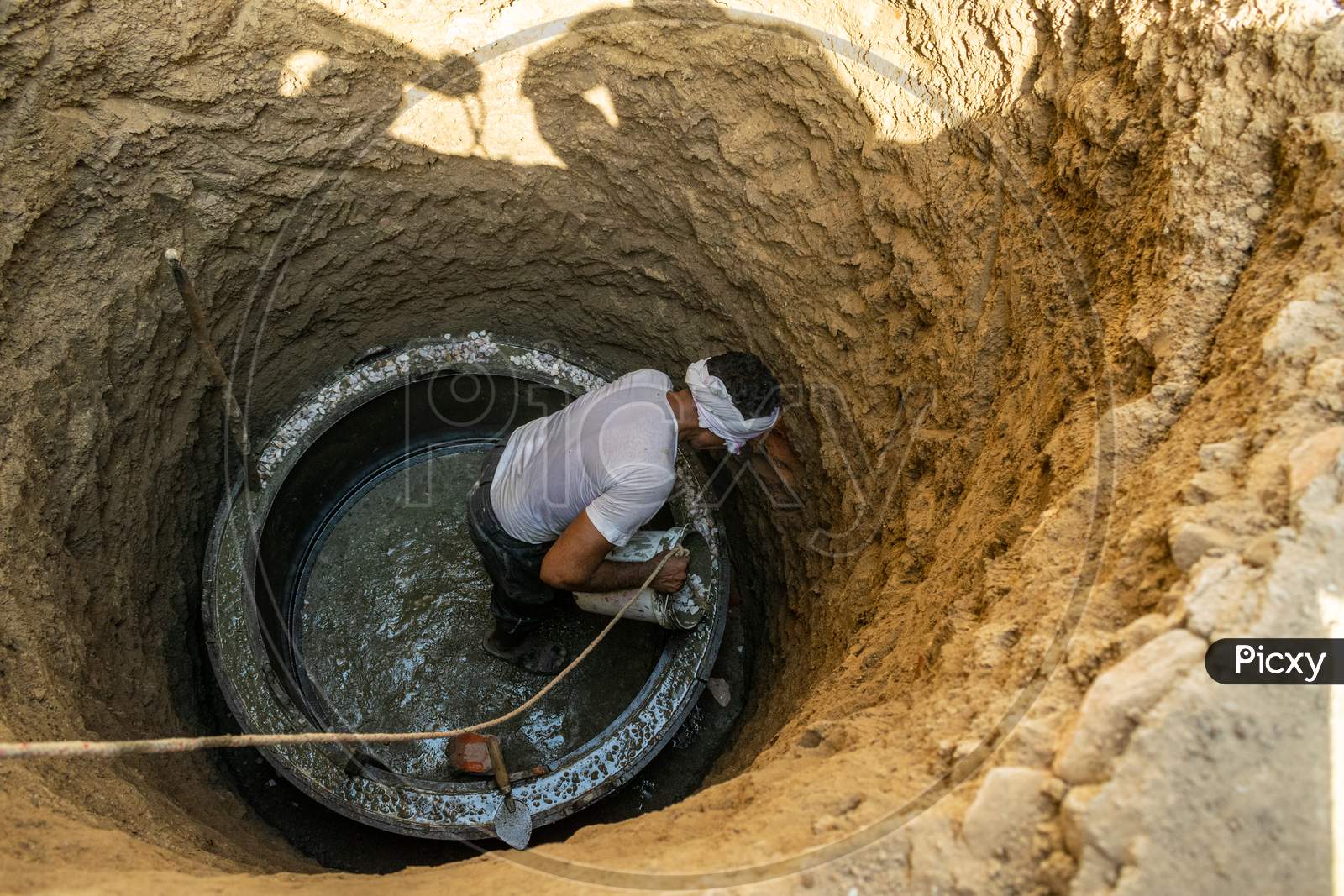 A man working during construction of septic tank