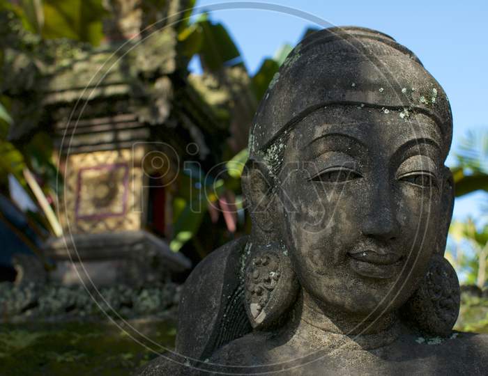 Close Up Picture Of A Female Like Stone Statue In Bali