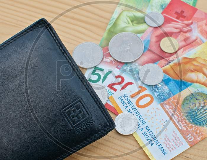 Black Wallet And Swiss Currency