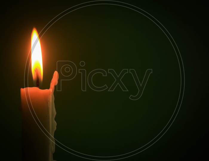 Single lit candle with quite flame