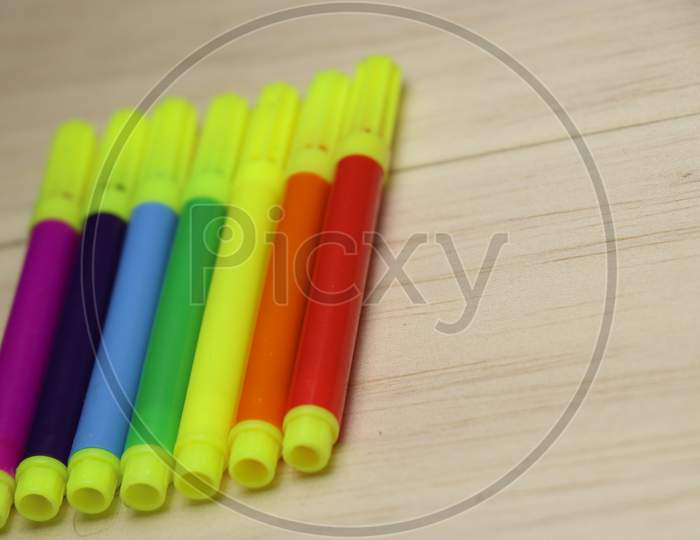 Color Pen Or Sketch Pen Arranged In Rainbow Format On Wooden Background
