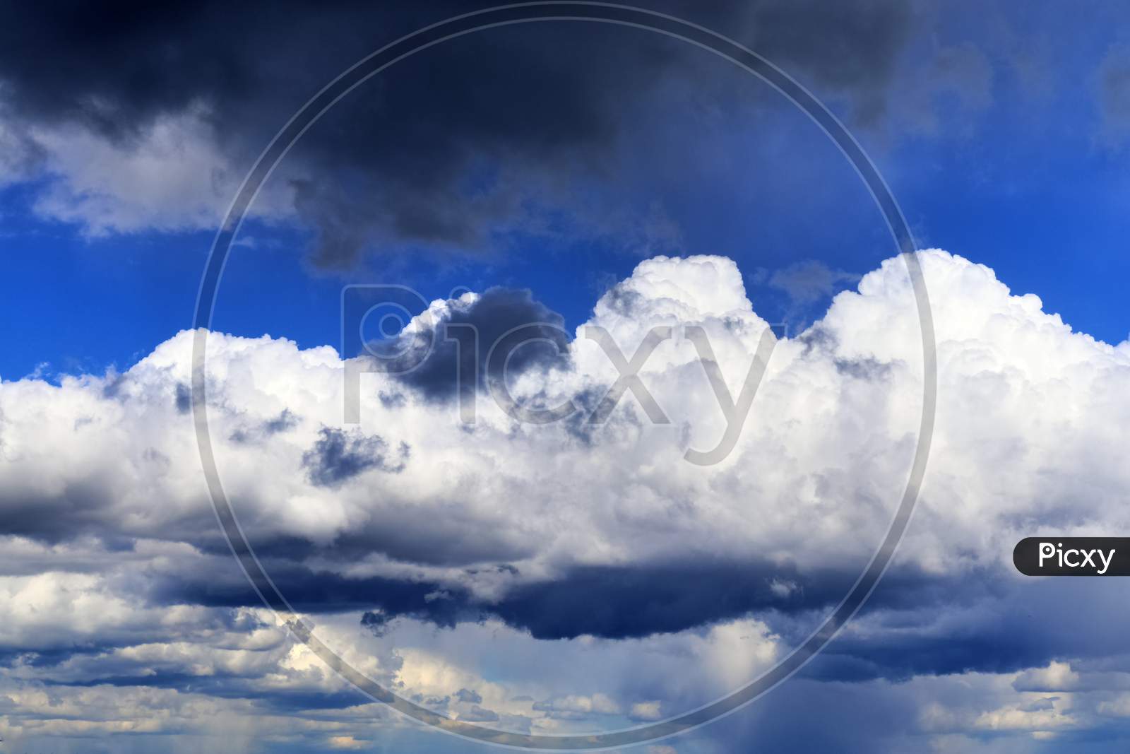 Beautiful white fluffy clouds in a deep blue summer sky