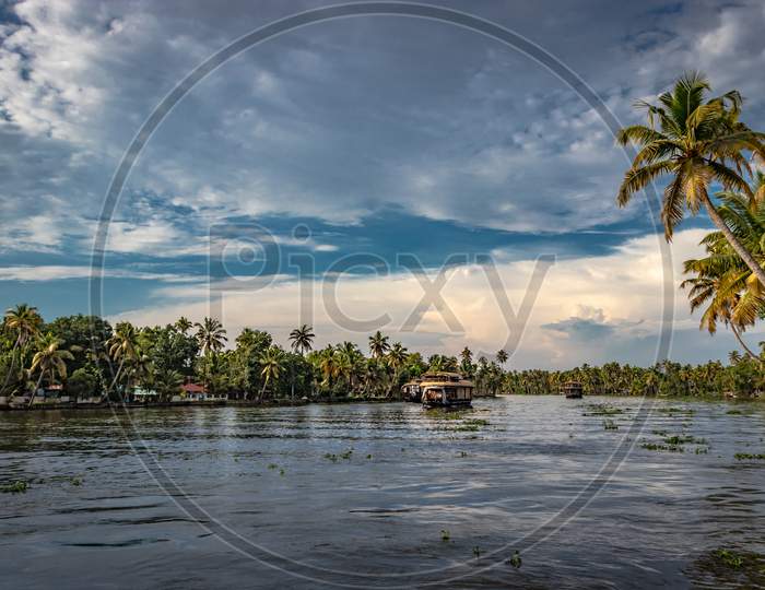 Houseboat In Backwater With Sky And Palm Tree
