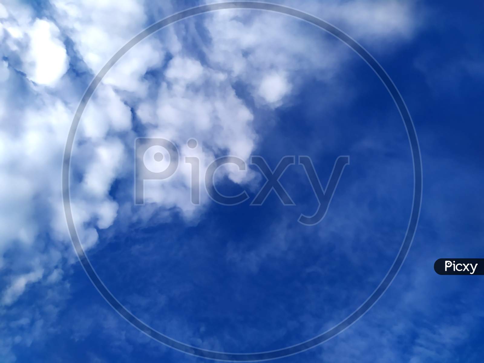 white rainy clouds flying in the blue sky