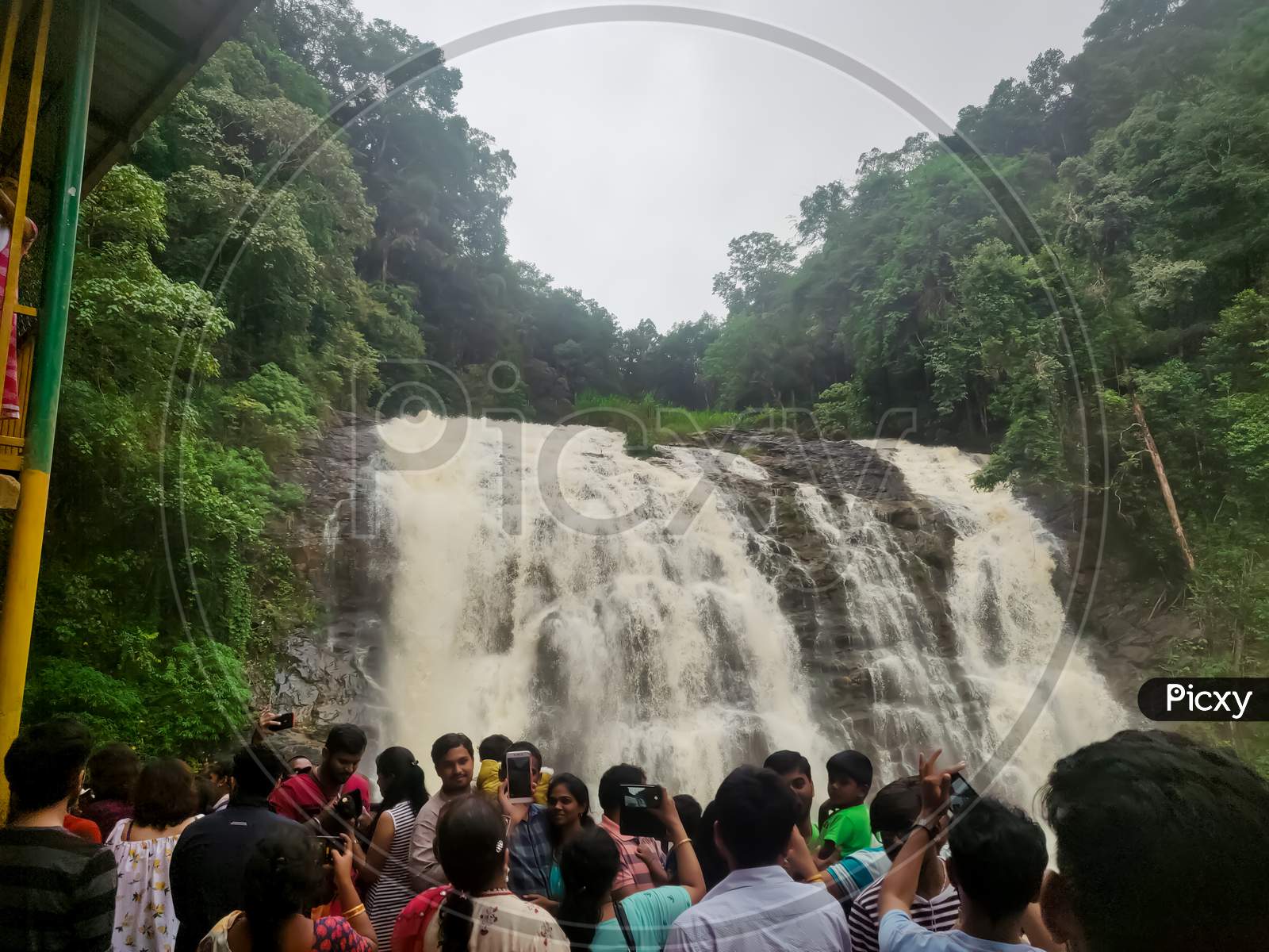 July 6, 2019- Karnataka, India: An Image Of A Abbey Waterfalls Covered With Green Forest In Coorg, Karnataka, India With People Watching Its Beauty.