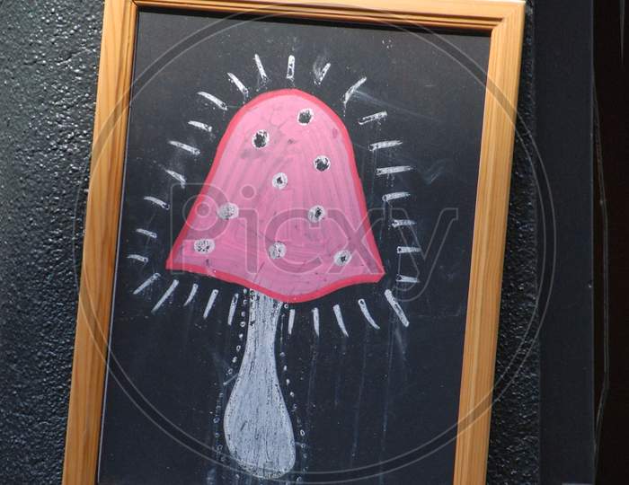 Pink Mushroom Sign In Amsterdam On A Narrow Street