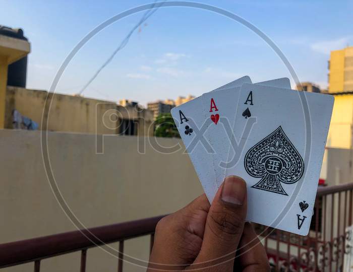 holding three cards in one hand with corporate background