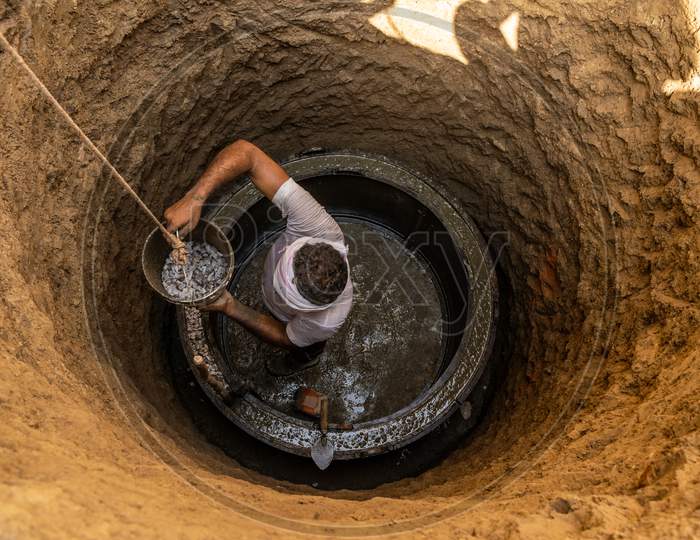 A man working during construction of septic tank