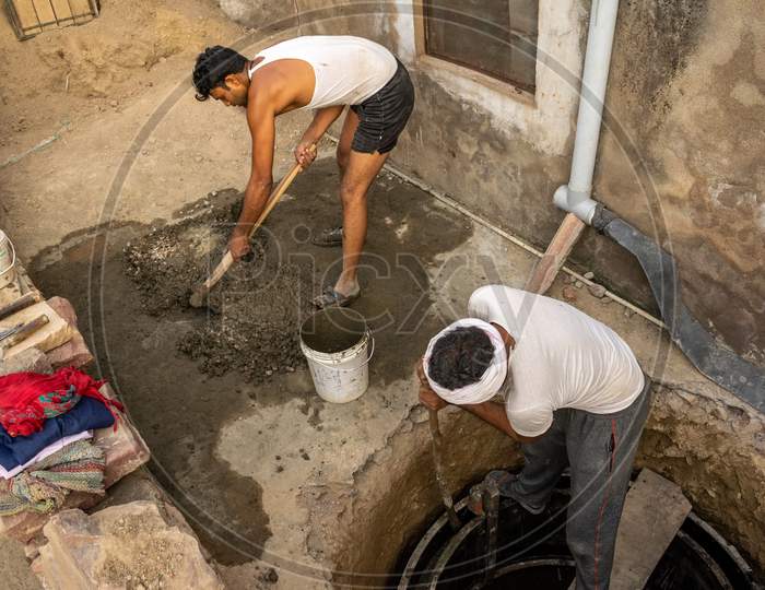 Men working during construction of a septic tank