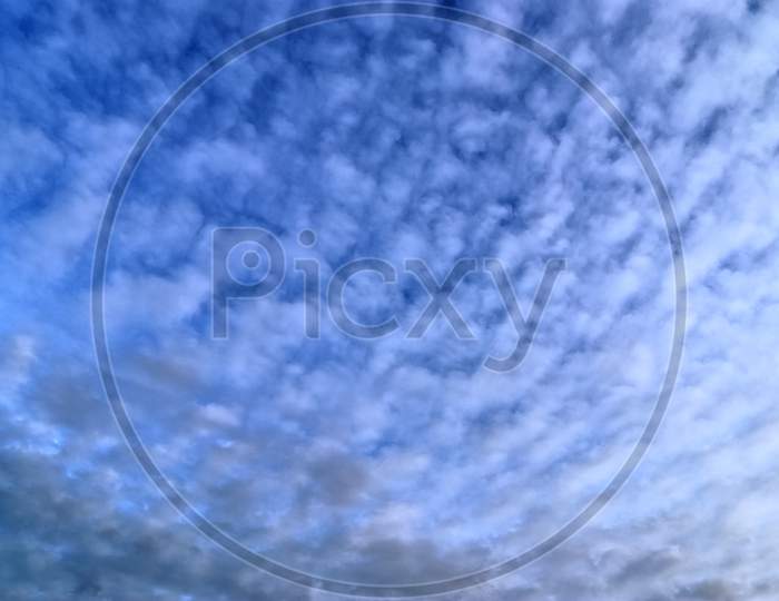 Beautiful white fluffy clouds in a deep blue summer sky