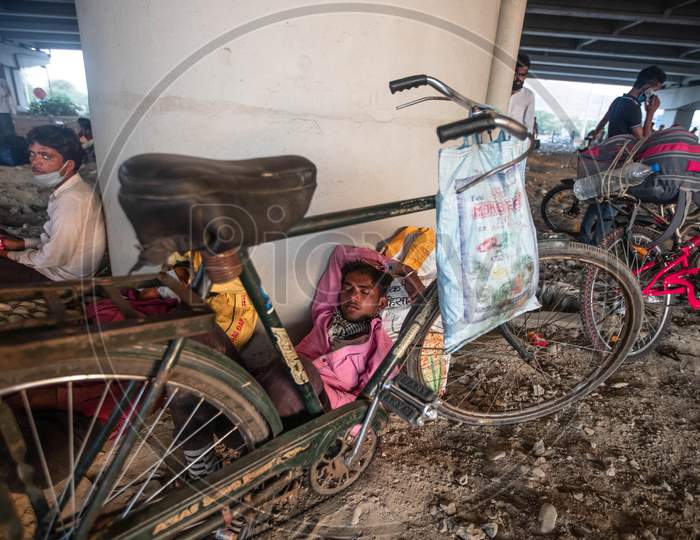 Migrant Worker Rest Under A Flyover While Peddling Back To His Village In Bhagalpur District Of Bihar, In New Delhi, India, On May 16, 2020.