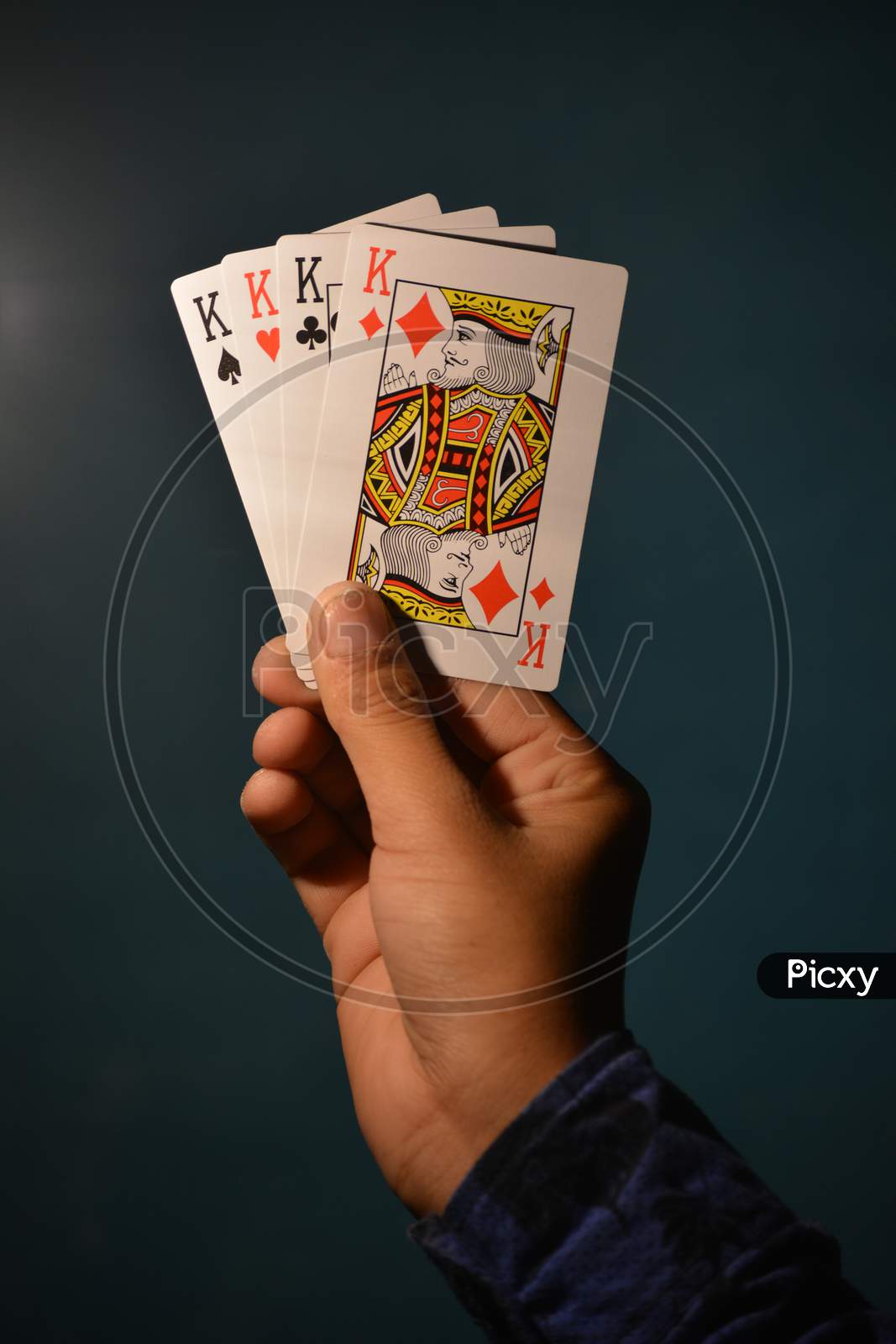 TIKAMGARH, MADHYA PRADESH, INDIA - DECEMBER 15, 2019: Hand holding all kings of playing card.