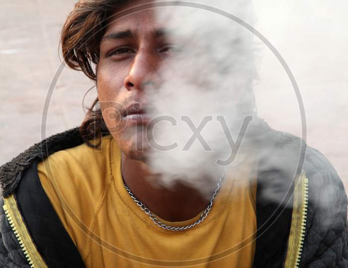 Portrait of a Young Indian Man smoking