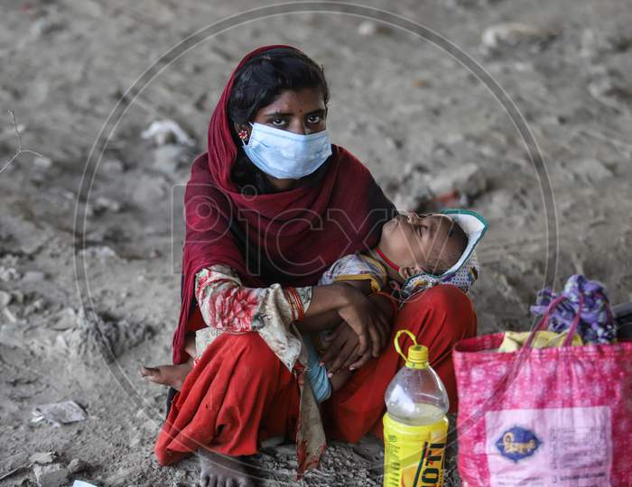 A Stranded Migrant Worker And A Child Rest Under A Flyover While On A Journey Back Home To Another State Amid The Lockdown, In Ghazipur, On May 16, 2020 In New Delhi, India.