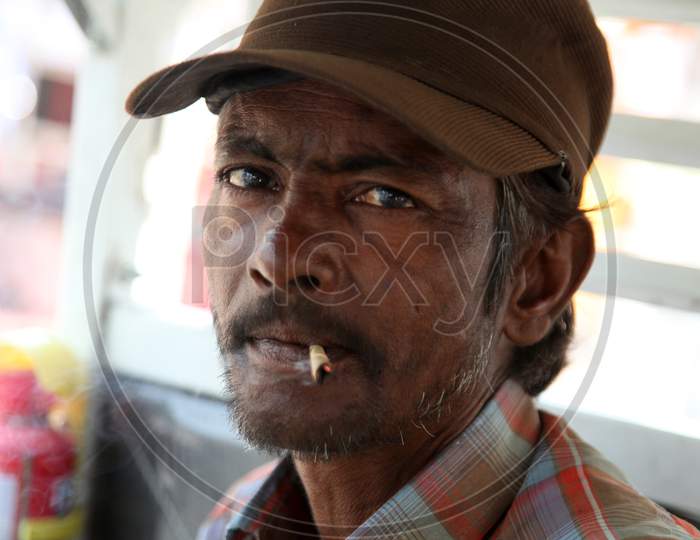 Portrait of an Indian Man smoking Beedi