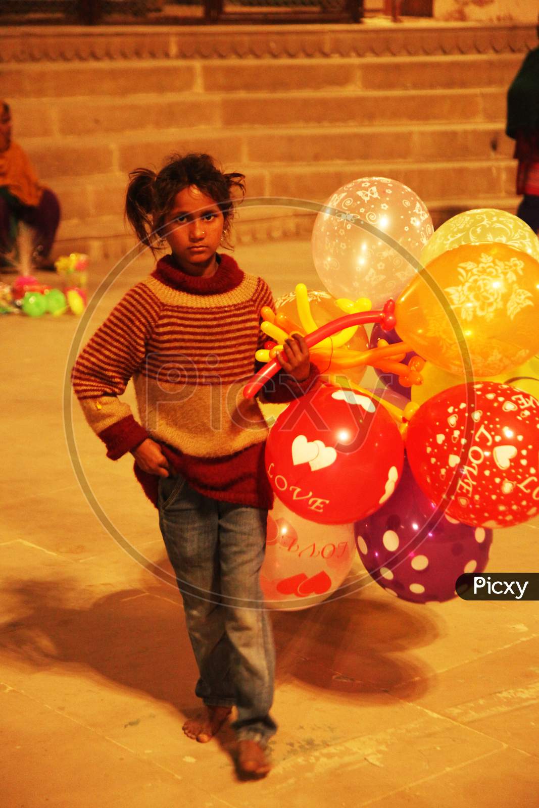 A Small Kid selling Ballons