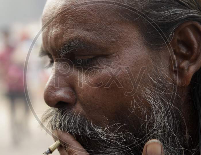 Portrait of an Old Indian Man smoking Beedi