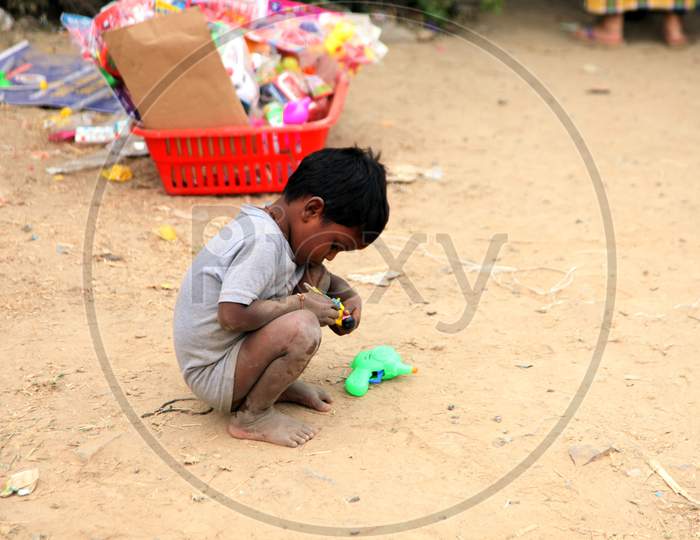 Photograph of a Rural kid sitting on Ground