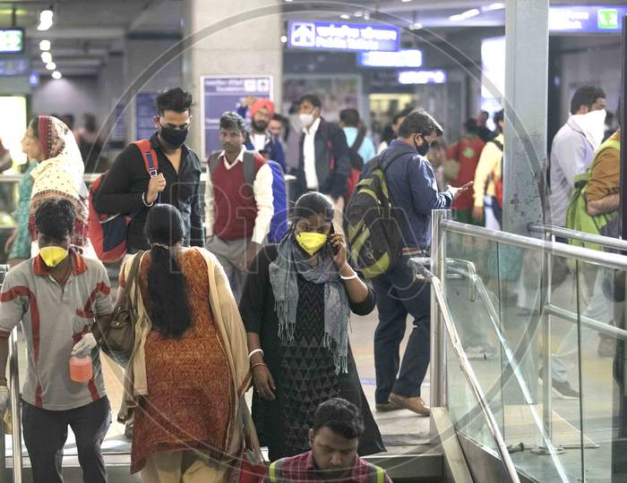 A People Wearing A Facemask As A Preventive Measure Against The Covid-19 Novel Coronavirus Walks Out Of A Metro Station In New Delhi On March 13, 2020.