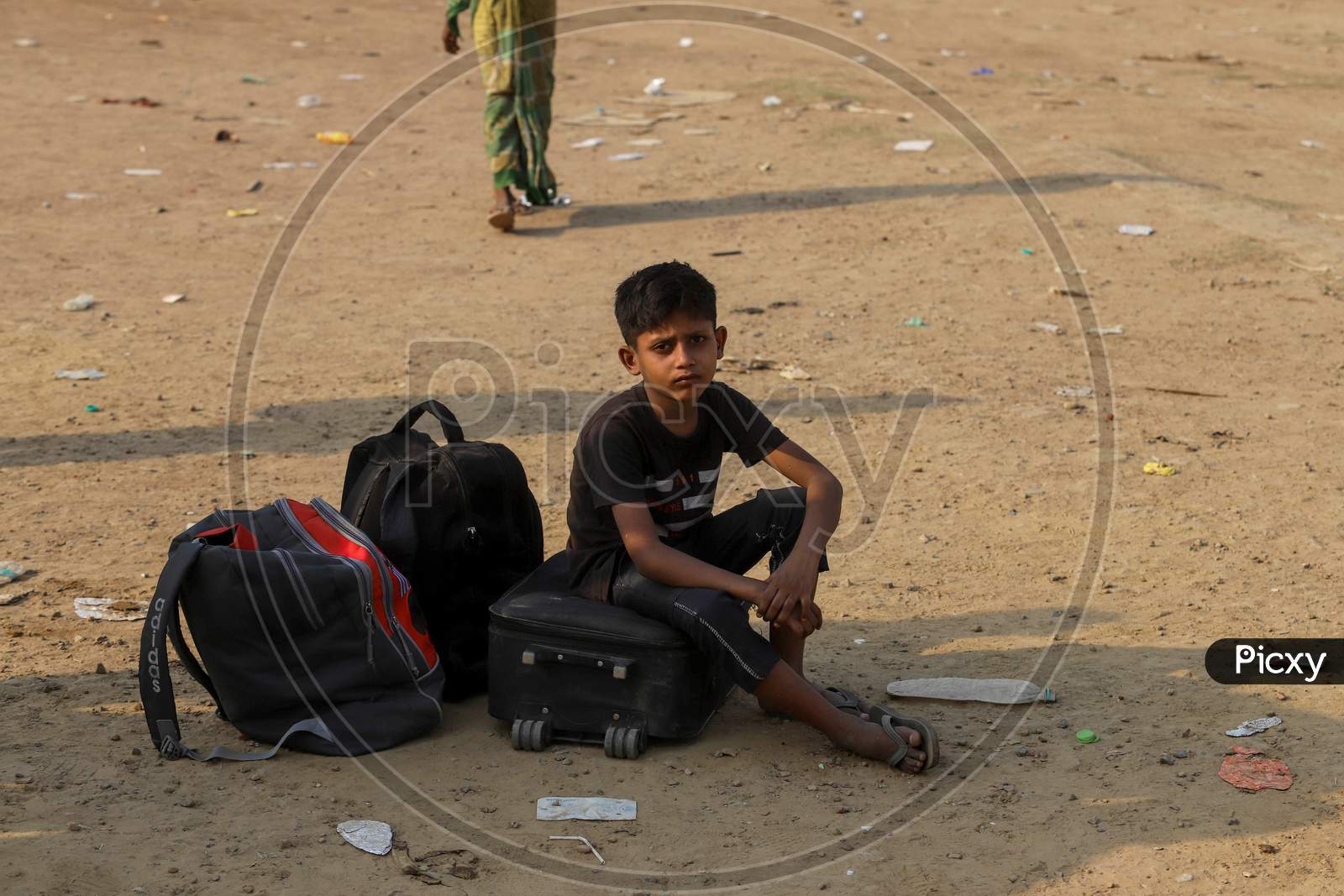 A Boy Waits With The Luggage  While On A Journey Back Home To Another State Amid The Lockdown, In Ghaziabad, On May 18, 2020 In New Delhi, India.