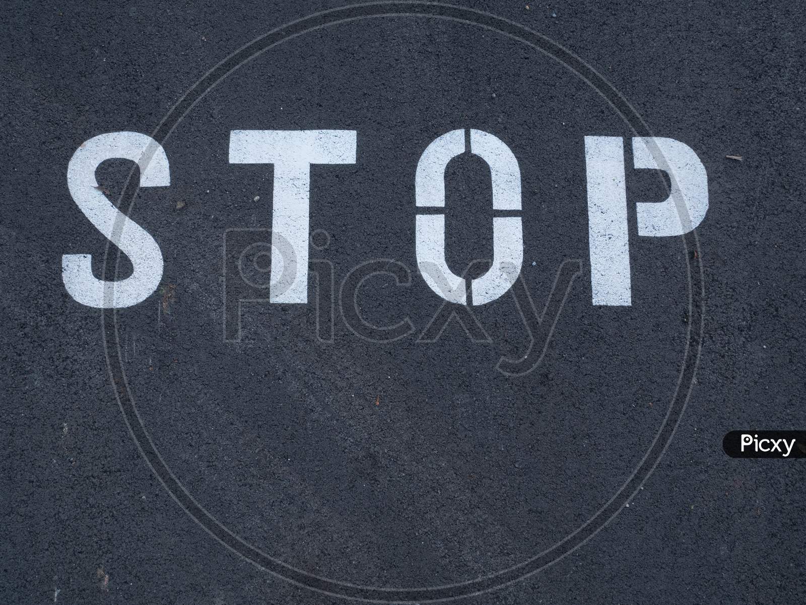 Stop Sign Painted On The Asphalt