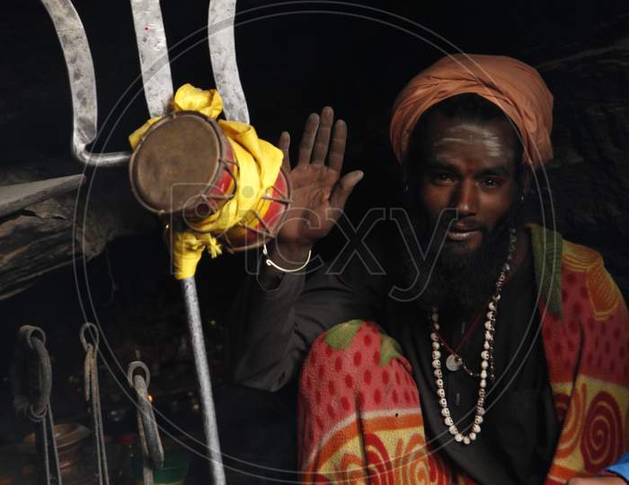 Portrait of an Indian Hindu Sadhu or Baba with Trishul in the foreground