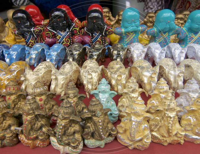 Many Colorful Ganesha, Elephants And Buddhas Statues
