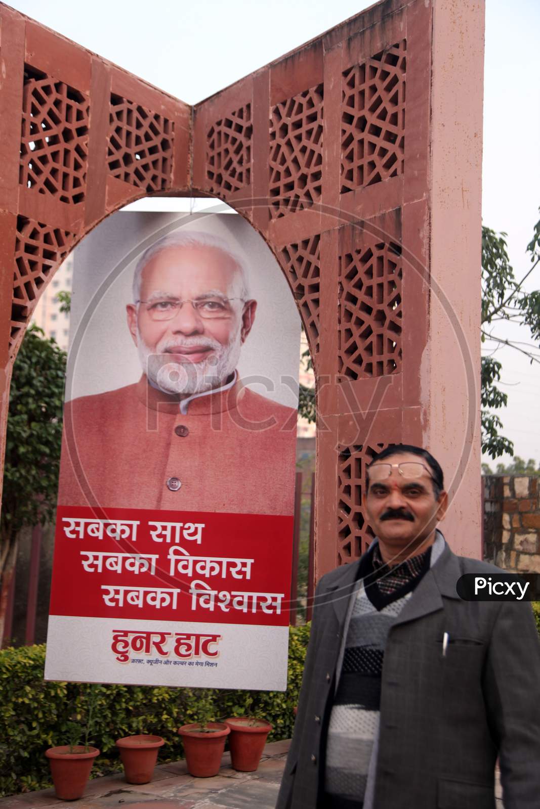 A Middle-Aged Indian Man with Shri Narendra Modi Poster