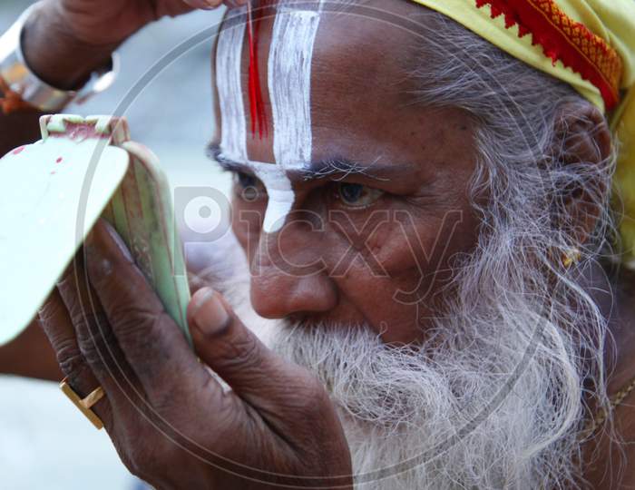 Portrait of an Old Indian Hindu Sadhu or Baba Keeping Namam for Forehead