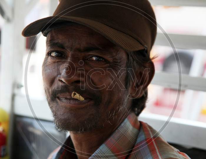 Portrait of an Indian Man smoking Beedi