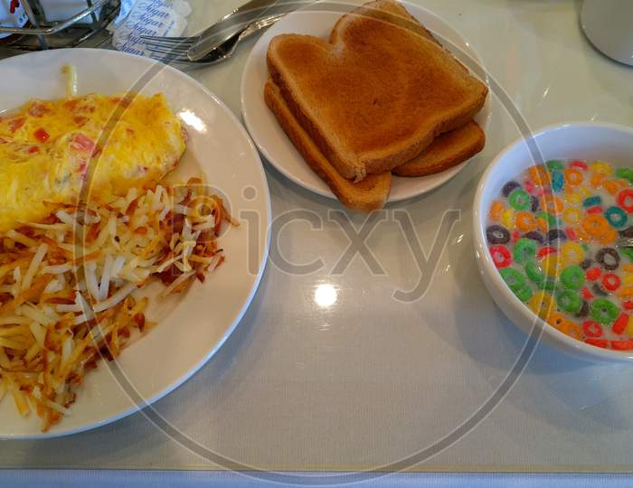 Perfect English Breakfast With Bread Toast Omelette Hash Brown And Froot Loop Cereal In Milk To Make The Start Of The Day Healthy