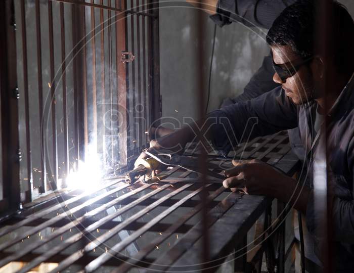 A Young Welder doing welding with Welding Goggles