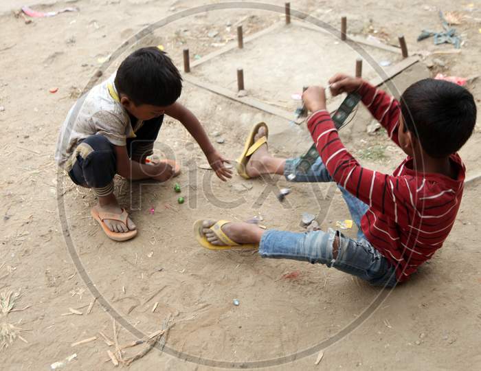 Photograph of an Indian Kids sitting on Ground