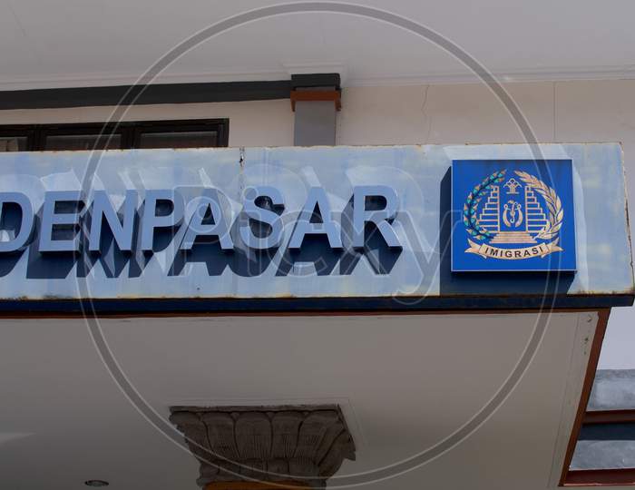 Close Up Of The Denpasar Text And Imigrasi (Immigration) Logo In Bali