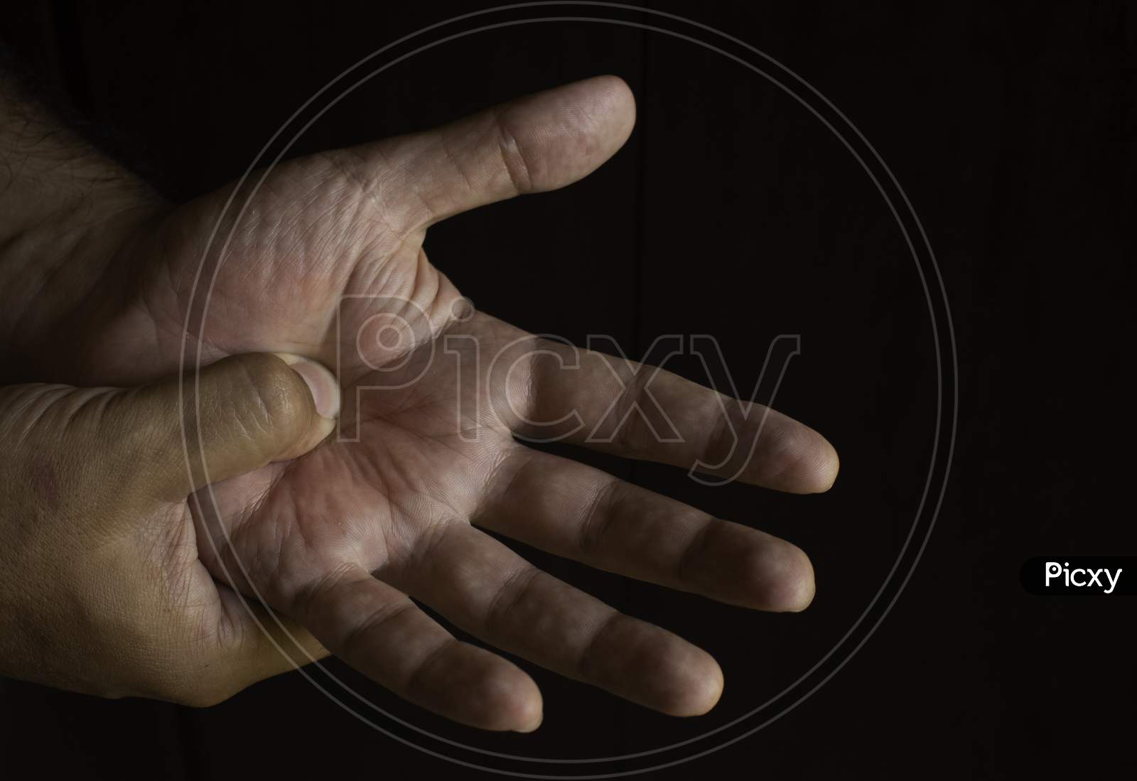 Adult Man With Pain In His Hands. Automassage Of Hands To Relieve Pain.