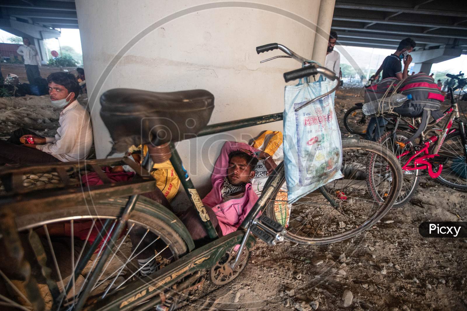 Migrant Worker Rest Under A Flyover While Peddling Back To His Village In Bhagalpur District Of Bihar, In New Delhi, India, On May 16, 2020.