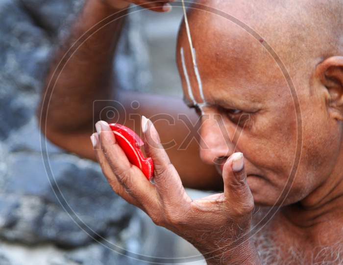 Portrait of a Middle-Aged Indian Man keeping namam