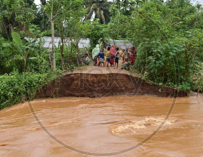 Villagers Watch A Washed Away Road After Flooding By Borpani River  Due To Incessant Rainfall For The Past Two Days, At  Madhab Para Near Kampur In Nagaon District Of Assam,India May 22,2020