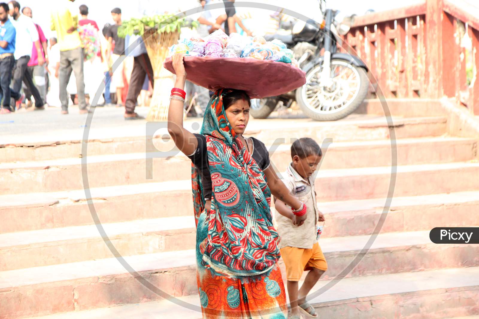 A Bangle Vendor with her Child