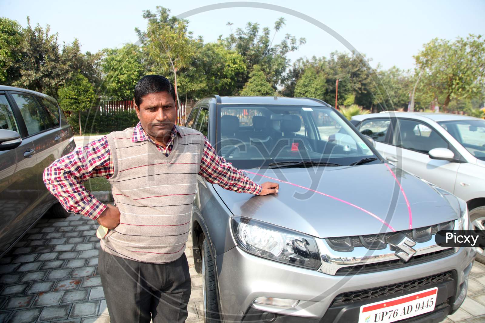 A Middle-Aged Indian man with a Car