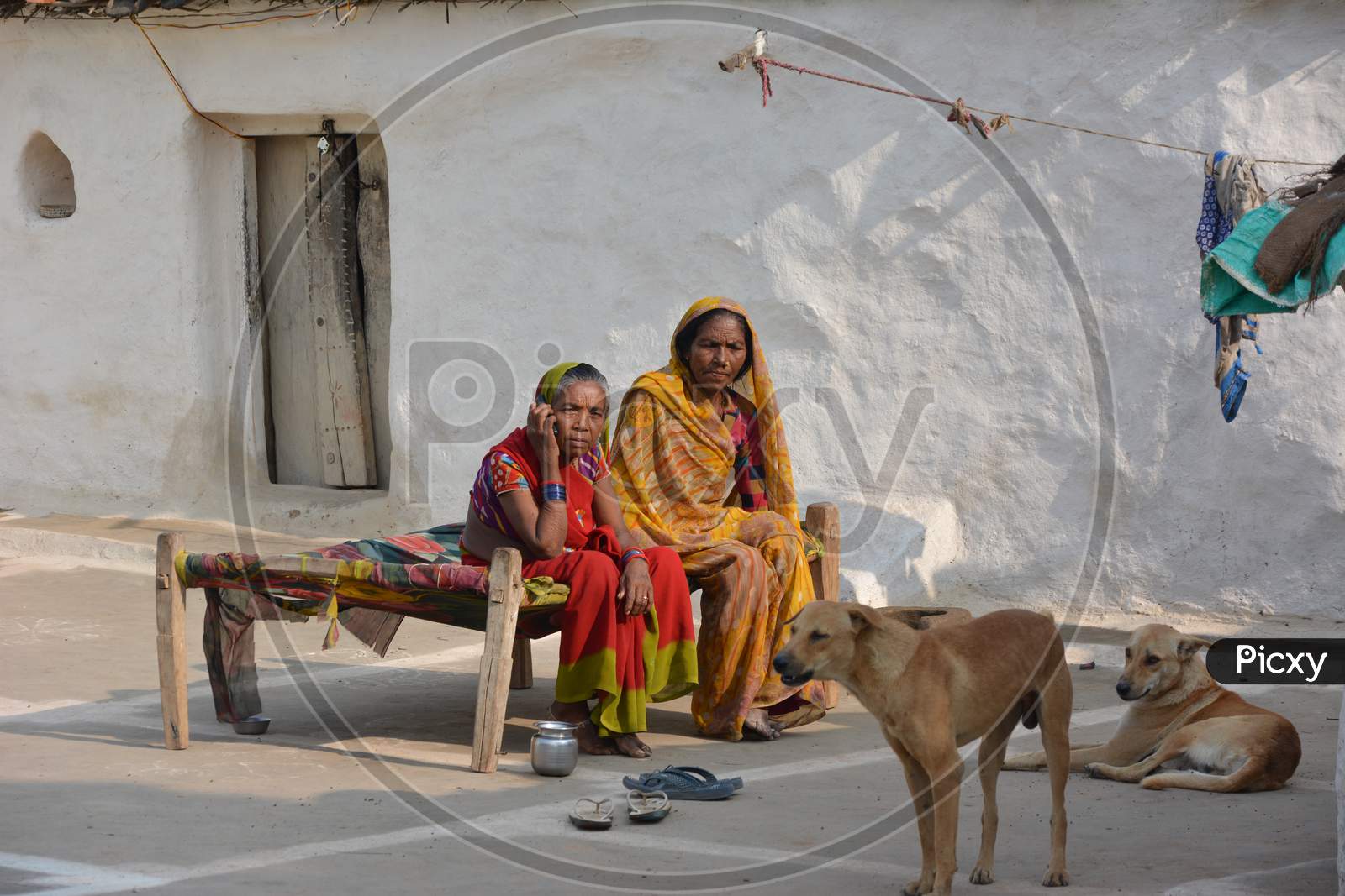 TIKAMGARH, MADHYA PRADESH, INDIA - NOVEMBER 15, 2019: Portrait of unidentified Indian women talking on mobile at her village.