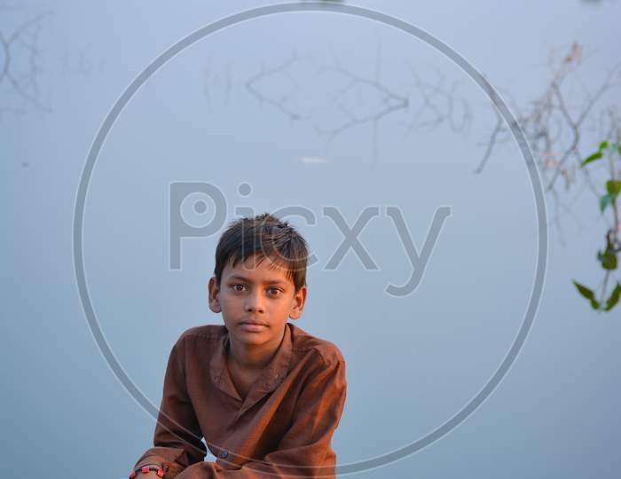 TIKAMGARH, MADHYA PRADESH, INDIA - NOVEMBER 13, 2019: Indian kid looking curious into the camera.